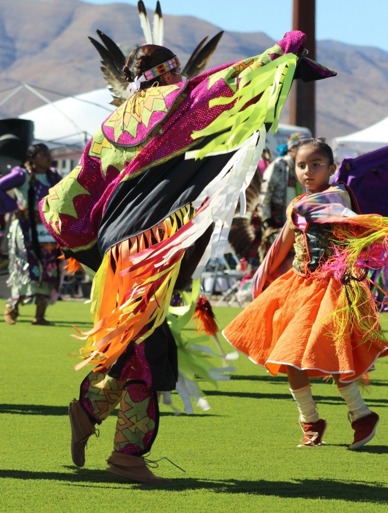 Snow Mountain Paiute Pow Wow Grand Entry - a girl watches her older sister as they dance together.