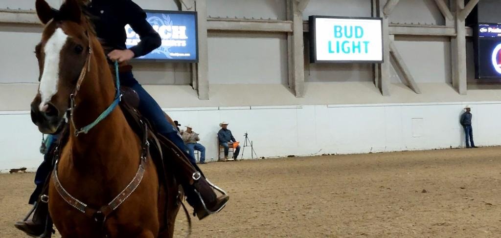 In pole-bending event, a tired horse and rider walk into the camera after time trials at Priefert Pavilion as seen at: rodeo Alamo HS; rodeo Battle Mountain HS; rodeo Boulder City HS; and rodeo Pahrump Valley.