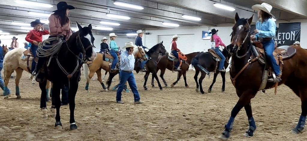 Pre-rodeo warmup arena, contestants exercise their horses as seen at: rodeo Elko HS; rodeo Eureka HS; rodeo Fernley HS; and rodeo Fallon HS.