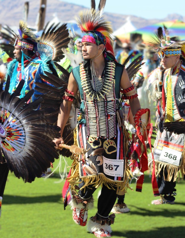 Snow Mountain Paiute Pow Wow Grand Entry as a young man dressed in finery follows the rhythms of the drums as seen in Powwows: Cedar; Cedar City; Duck Valley; Elko; Ely; Fallon; Fort Mojave; Goshute; Moapa; Muckleshoot; Nevada Day; Numaga; Red Dress; Sacred Visions; Stewart; Sycuan; UNLV;  UNR; Univ. of Nev. Reno; and Walker River; Western Navajo Fair.