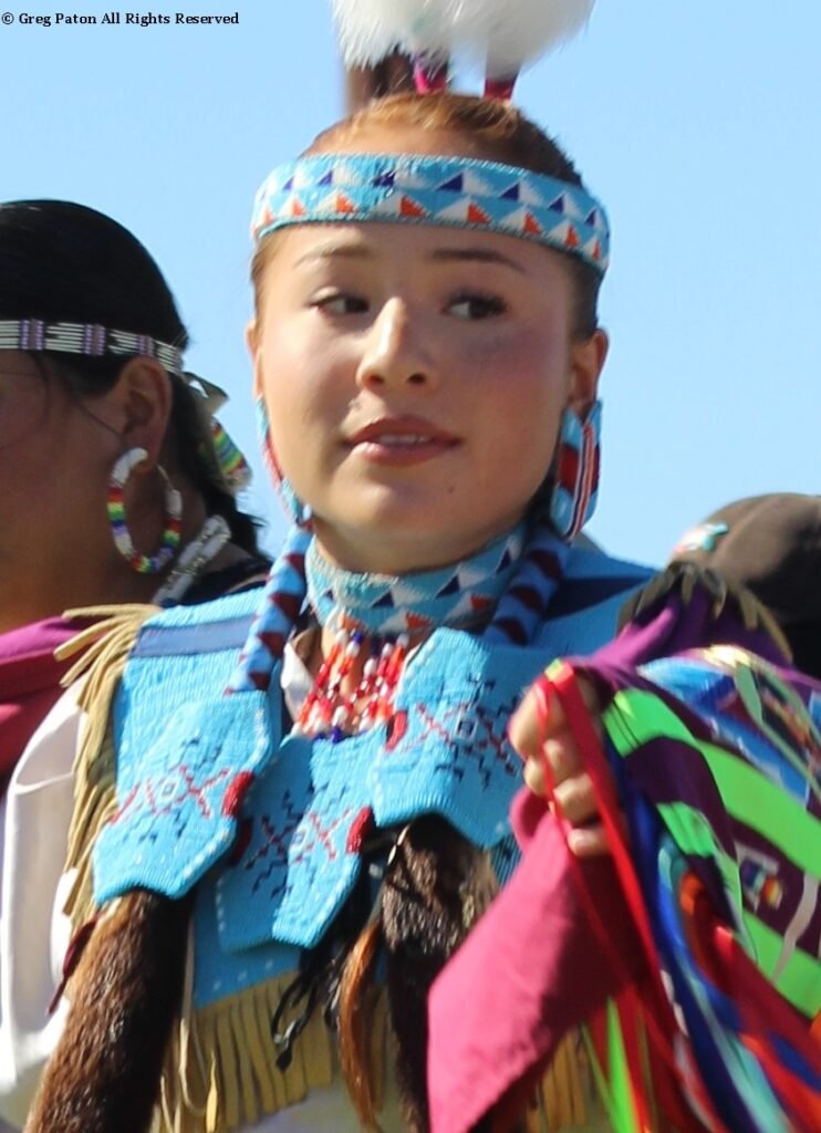 Snow Mountain Paiute Pow Wow Grand Entry as young Sycuan Princess talks with friends at the end of the Grand Entry as seen in powwows: Las Vegas Snow Mountain Paiute; Moapa; Moapa Valley; Muckleshoot; Nevada Day; Numaga; Pahrump; Pahrump Valley; Pahrump Valley Social; Pahrump Social and Sycuan.