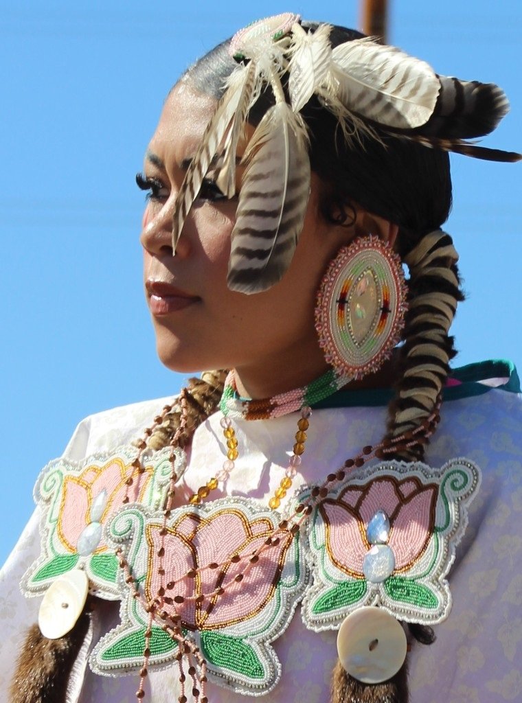 Closeup of a beautiful Native American female in the Grand Entry as seen in powwows: Lakota; Mohave; Mojave; Mohawk; Mohegan; Muscogee; Muscogee Nation; Nakota; Navajo; and Navajo Nation.